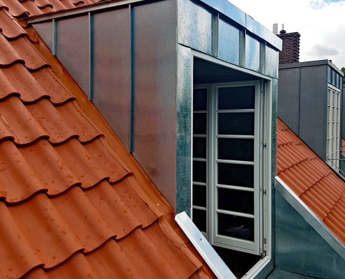 Eine hochwertig mit Metall verschalte Gaube mit Fensteraustritt zum Dachbalkon.